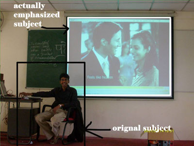 Classroom, student in front of projected screen: by Ashveen