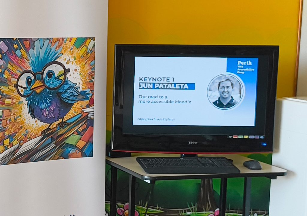 Widescreen session posters being shown on a display at the venue