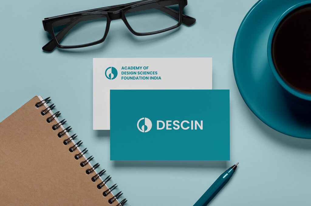 Business card mockup showing DESCIN logo and logotype