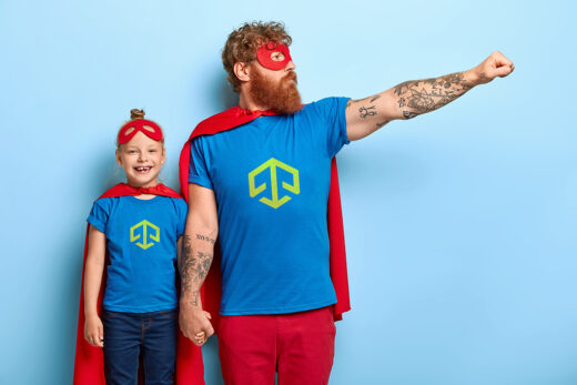 Father and daughter wearing superhero costumes featuring the Cyber Tech Force logo